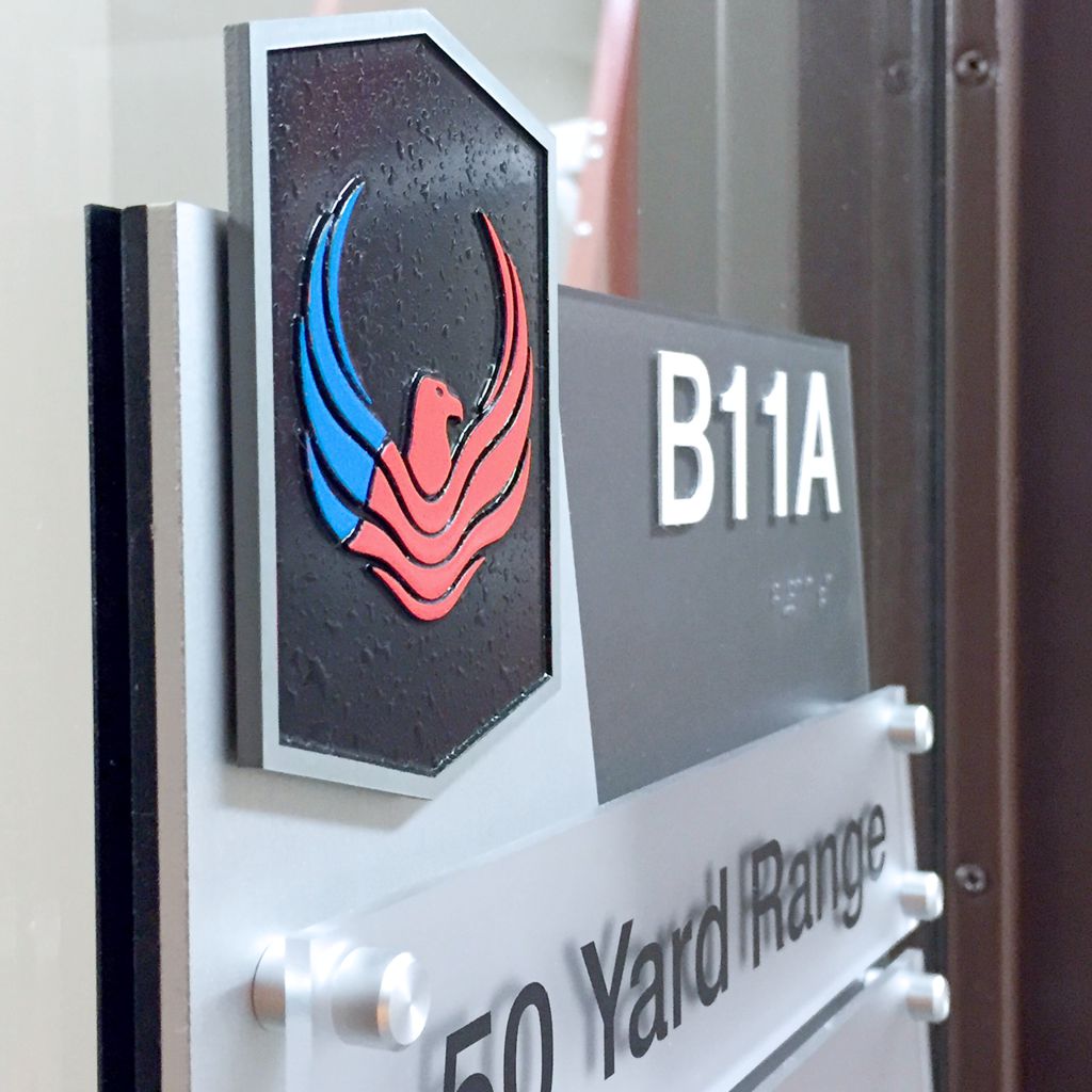 A sign with a black and red phoenix logo at the top, labeled "B11A". Below it reads "50 Yard Range".