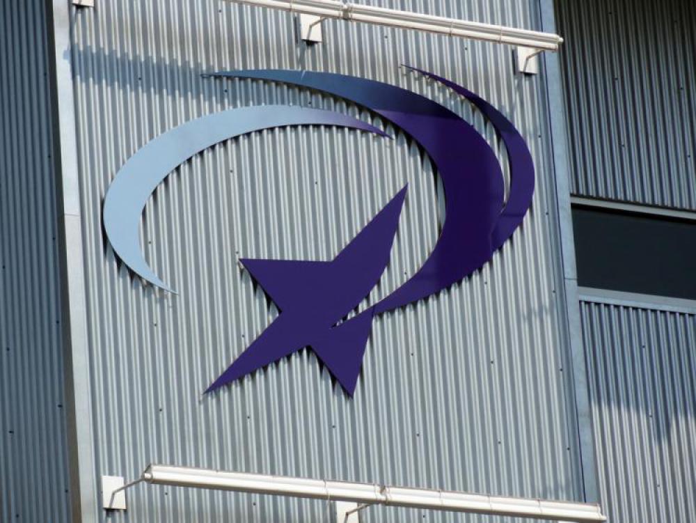 A modern building with a logo of a shooting star on it. The structure features a mix of brick and metal siding.