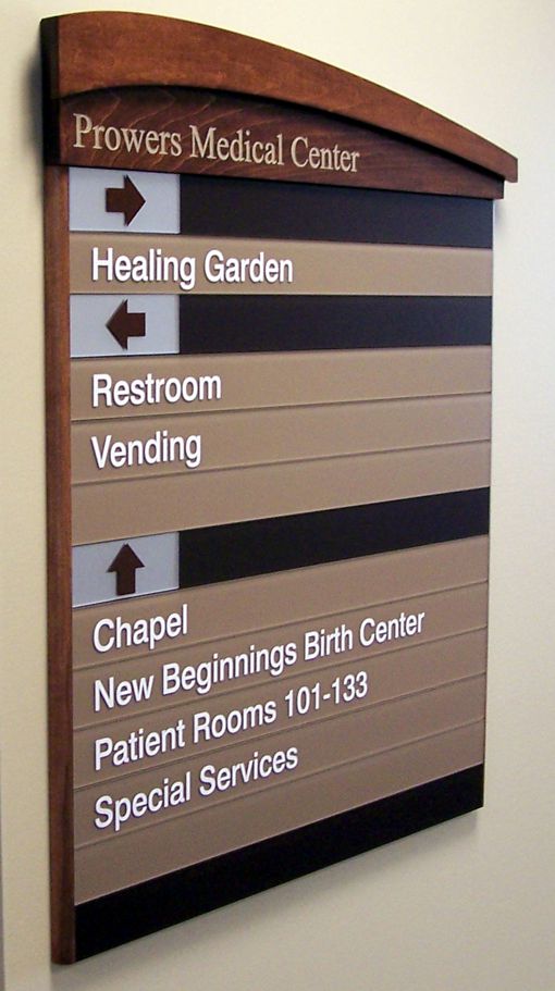 A directional sign in Prowers Medical Center shows arrows to various locations: Healing Garden, Restroom, Vending, Chapel, New Beginnings Birth Center, Patient Rooms 101-133, and Special Services.