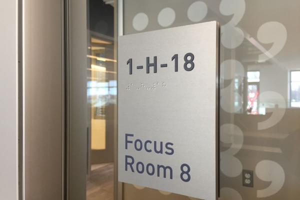 Soft brushed aluminum ADA signs with digitally printed room name.