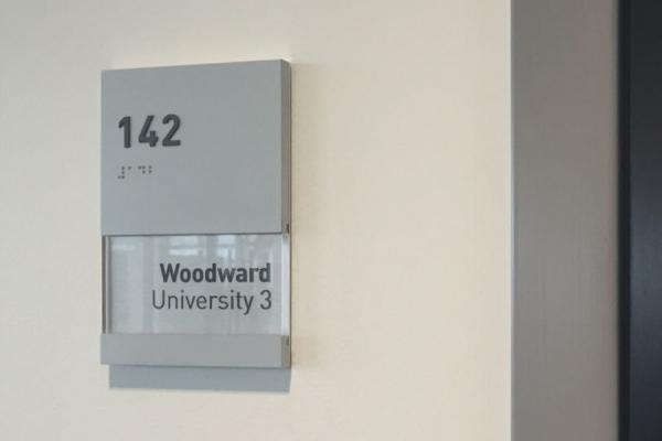 Brushed aluminum ADA signs with window inserts