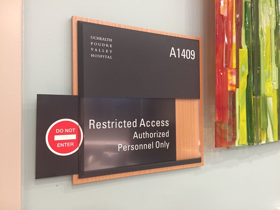 A sign on a wall at Elizabeth Young Valley Hospital labeled "A1409" indicates restricted access with the message, "Restricted Access Authorized Personnel Only." A red "Do Not Enter" symbol is also visible below the sign.