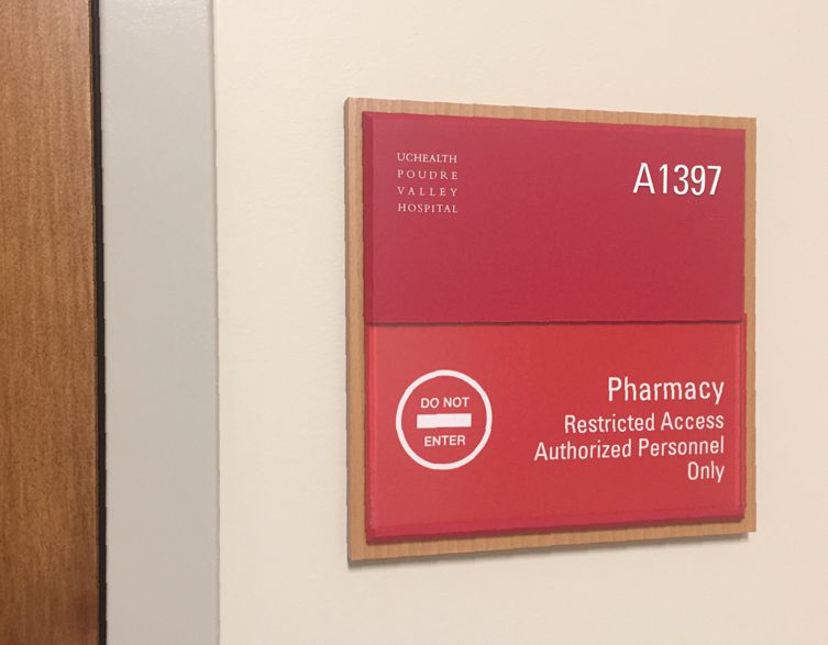 A red sign on a wall reads, "Pharmacy A1397" and "Restricted Access Authorized Personnel Only" with a "DO NOT ENTER" symbol.