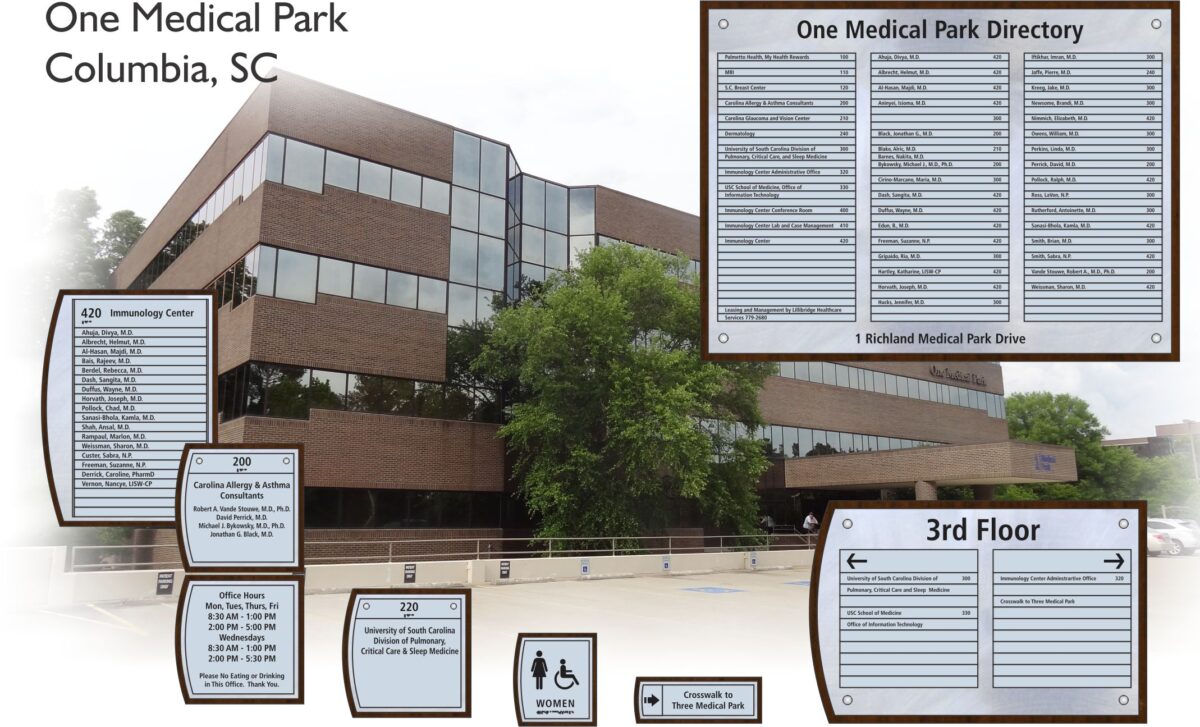 A multi-story brick and glass building labeled "One Medical Park, Columbia, SC." Various directory signs detail clinic names and locations within the building. Signs indicate restrooms, crosswalk, and specific departments such as "Immunology Center" and "Children's Health.