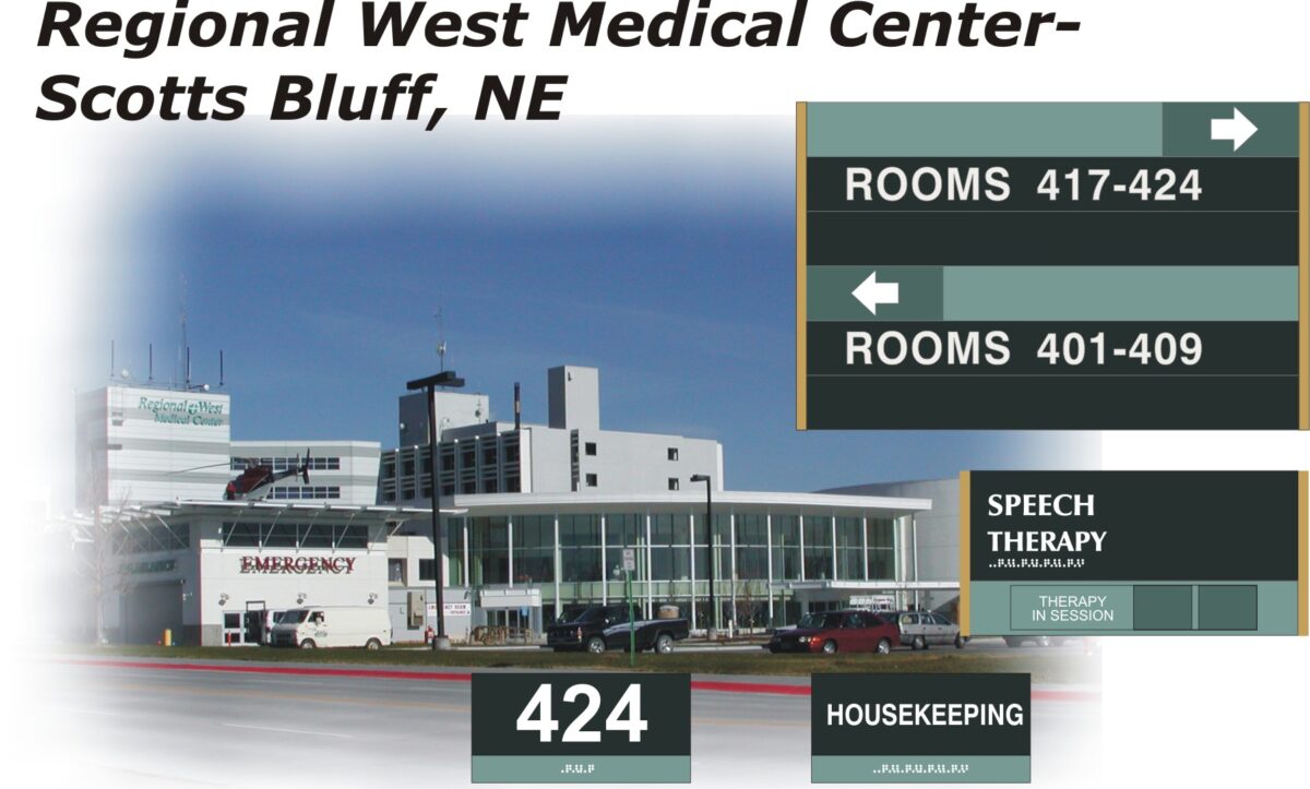 An exterior view of Regional West Medical Center in Scotts Bluff, NE with signs pointing to rooms 417-424, rooms 401-409, speech therapy, therapy in session, room 424, and housekeeping. The main building entrance and emergency room are visible.
