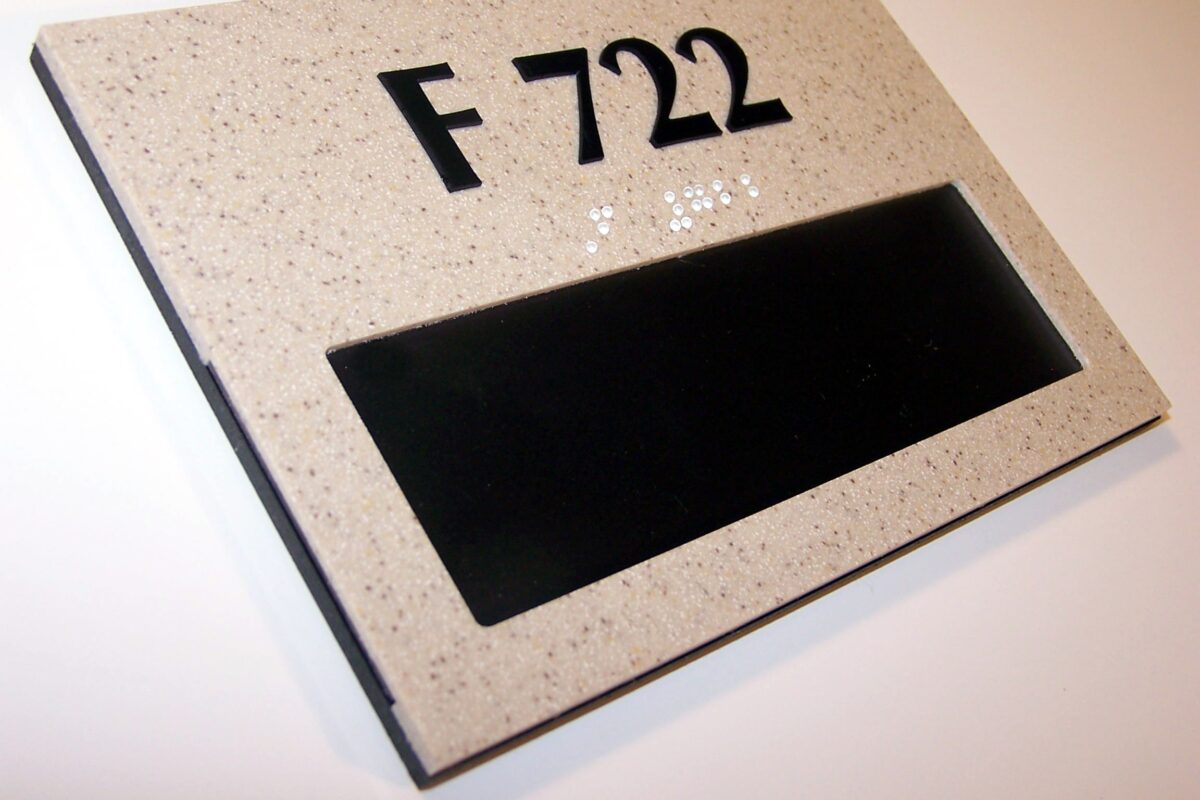 A gray rectangular sign with black text displaying "F 722" positioned on a white background. Below the text is a black empty rectangular space, possibly for customizable text or additional information. The sign appears to be mounted on a wall.