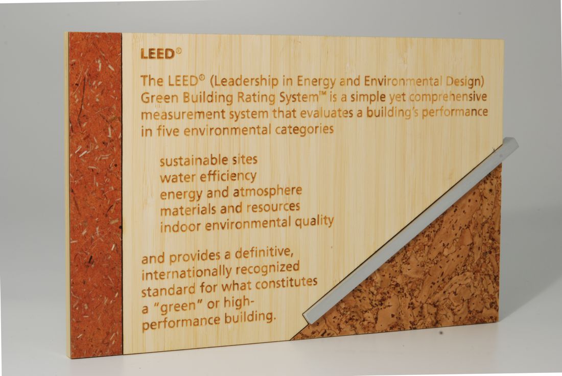 A display board with the title "LEED" explaining the Leadership in Energy and Environmental Design Green Building Rating System. It lists categories: sustainable sites, water efficiency, energy and atmosphere, materials and resources, and indoor environmental quality.