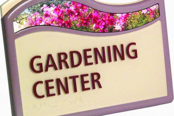 Colorful sign for a Gardening Center, enhanced with a floral image on top.