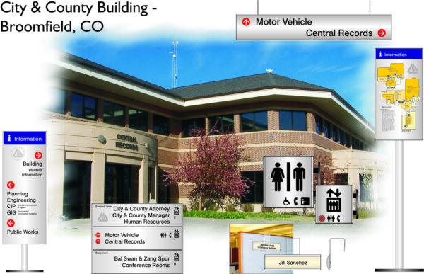 An image of the City & County Building in Broomfield, CO. The building is central in the image with various directional and informational signs around it, including ones for motor vehicle services, Central Records, public restrooms, and different department offices.