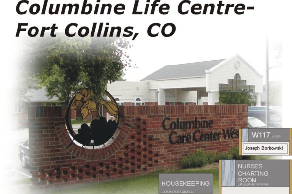 Entrance of Columbine Life Centre in Fort Collins, CO. The image shows a brick sign with the center's name in the front, a facility in the background, and signage inside reading "W117 Joseph Borkowski," "HOUSEKEEPING," and "NURSES CHARTING ROOM.