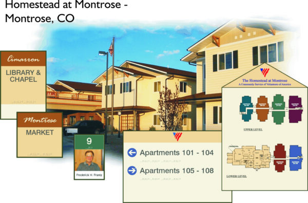 Image of a residential complex named Homestead at Montrose in Montrose, CO. The picture shows signs directing to the library, market, and apartments (101-104 and 105-108). A map of the complex is also displayed, depicting the layout of the upper and lower levels.