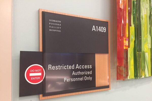 A sign on a wall at Elizabeth Young Valley Hospital labeled "A1409" indicates restricted access with the message, "Restricted Access Authorized Personnel Only." A red "Do Not Enter" symbol is also visible below the sign.