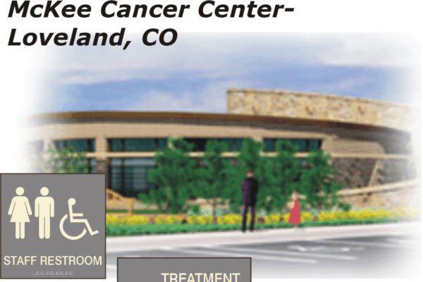 Illustration of McKee Cancer Center in Loveland, CO. The design features a modern building with stone and glass elements. In the foreground, signage indicates locations for "Staff Restroom" and "Treatment Planning Office." Two people are walking toward the entrance.
