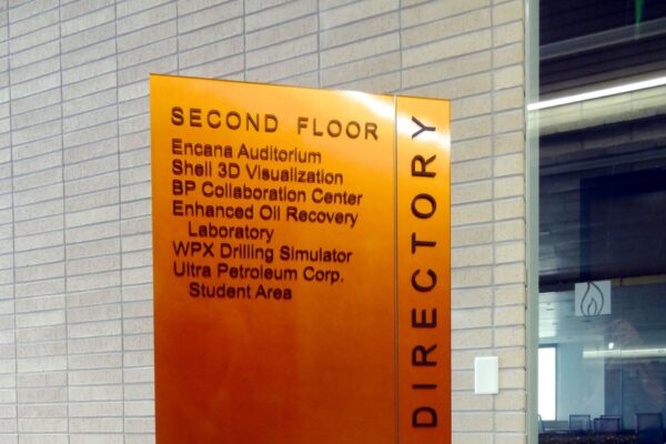 An upright directory sign with "SECOND FLOOR" at the top, listing locations: Encana Auditorium, Shell 3D Visualization, BP Collaboration Center, Enhanced Oil Recovery Laboratory, WPX Drilling Simulator, Ultra Petroleum Corp., and Student Area.