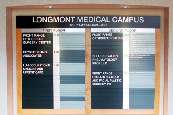 A directory sign for Longmont Medical Campus at 1551 Professional Lane. It lists offices on the first and second floors, including Front Range Orthopedic Surgery Center, Physiotherapy Associates, LLM Occupational Medicine and Urgent Care, and more.